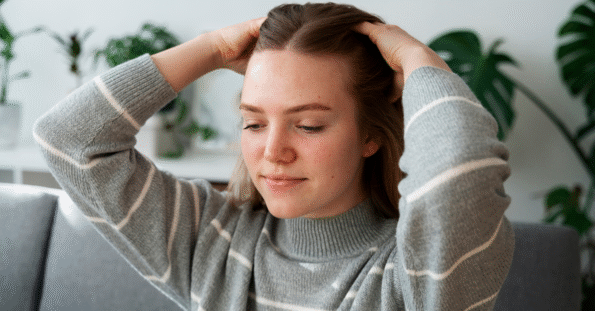 Woman experiencing stress-related hair loss